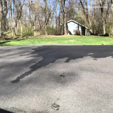 Guy grey sweats black shirt tries to do longboard skateboard slide fails concrete