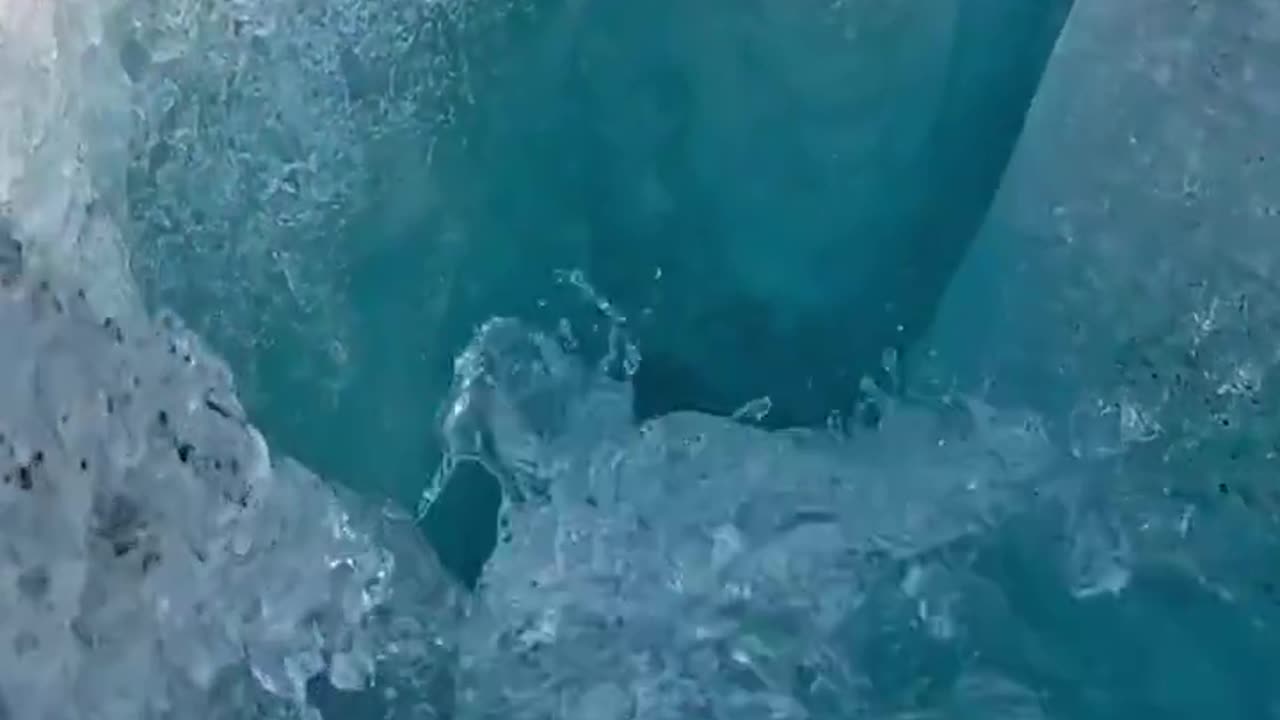 Water flowing into mysterious caverns beneath a massive glacier in Alaska