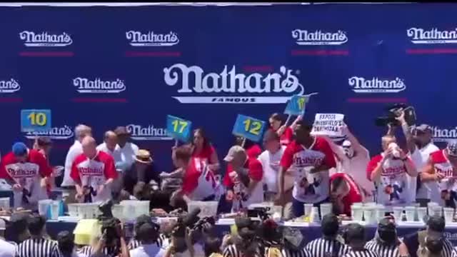 Protestor Gets HAMMERED After Interrupting Hot Dog Eating Contest