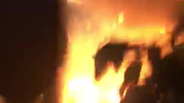 Group of kids watch fireworks they go off under car
