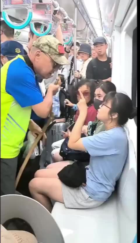 A man on a subway in northern China forcibly demanding a seat from a girl.