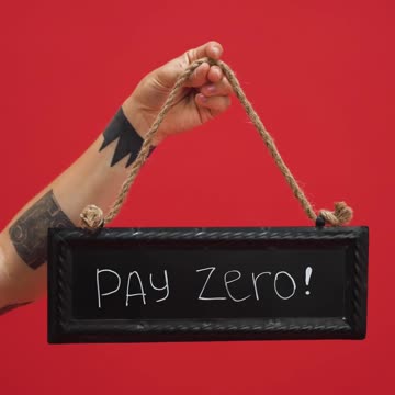 Person Holding Signage with a Message of Zero Interest