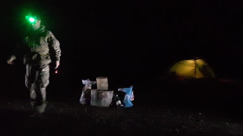 Lighting and camera is tradybto film chopping wood at night..