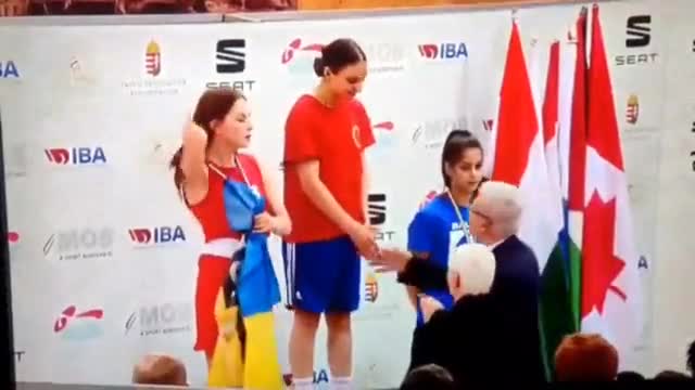 Ukrainian boxer Diana Petrenko proudly unfurls the neo-Nazi Avoz Battalion flag