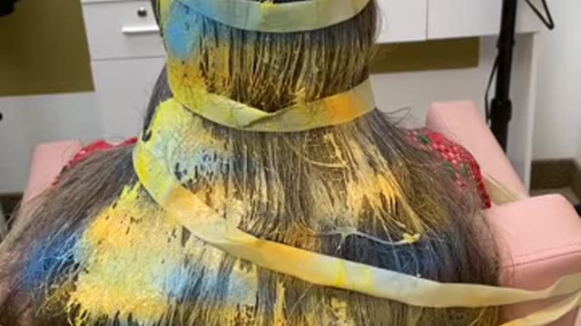 barber creates hairdo using tape…