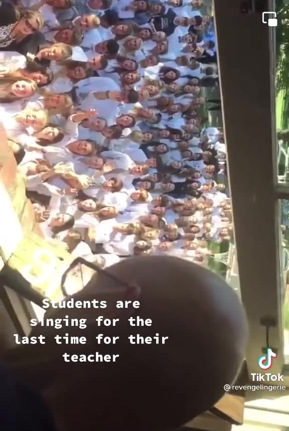 Students singing one last time for their teacher