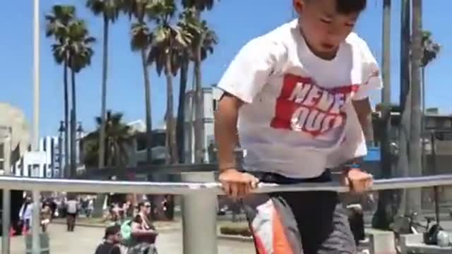 Kid Performs Stunts on Bars