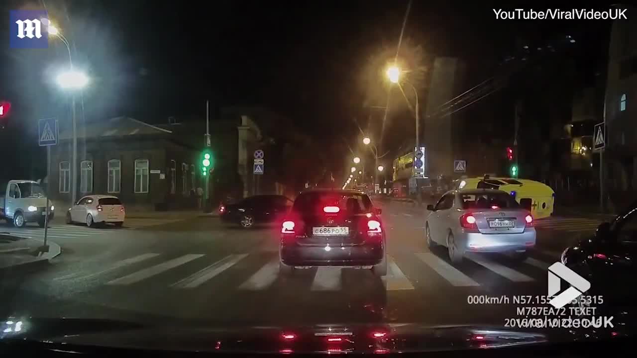 Crazy moment ambulance flips over after car collision in Russia