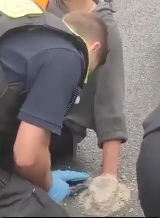 Climate activist glues herself to the road with cement to protest climate change