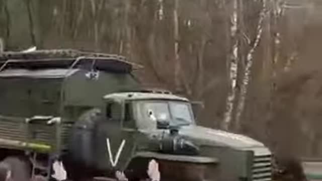 People greeting a Russian military column heading to the front in the Kursk oblast