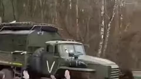 People greeting a Russian military column heading to the front in the Kursk oblast