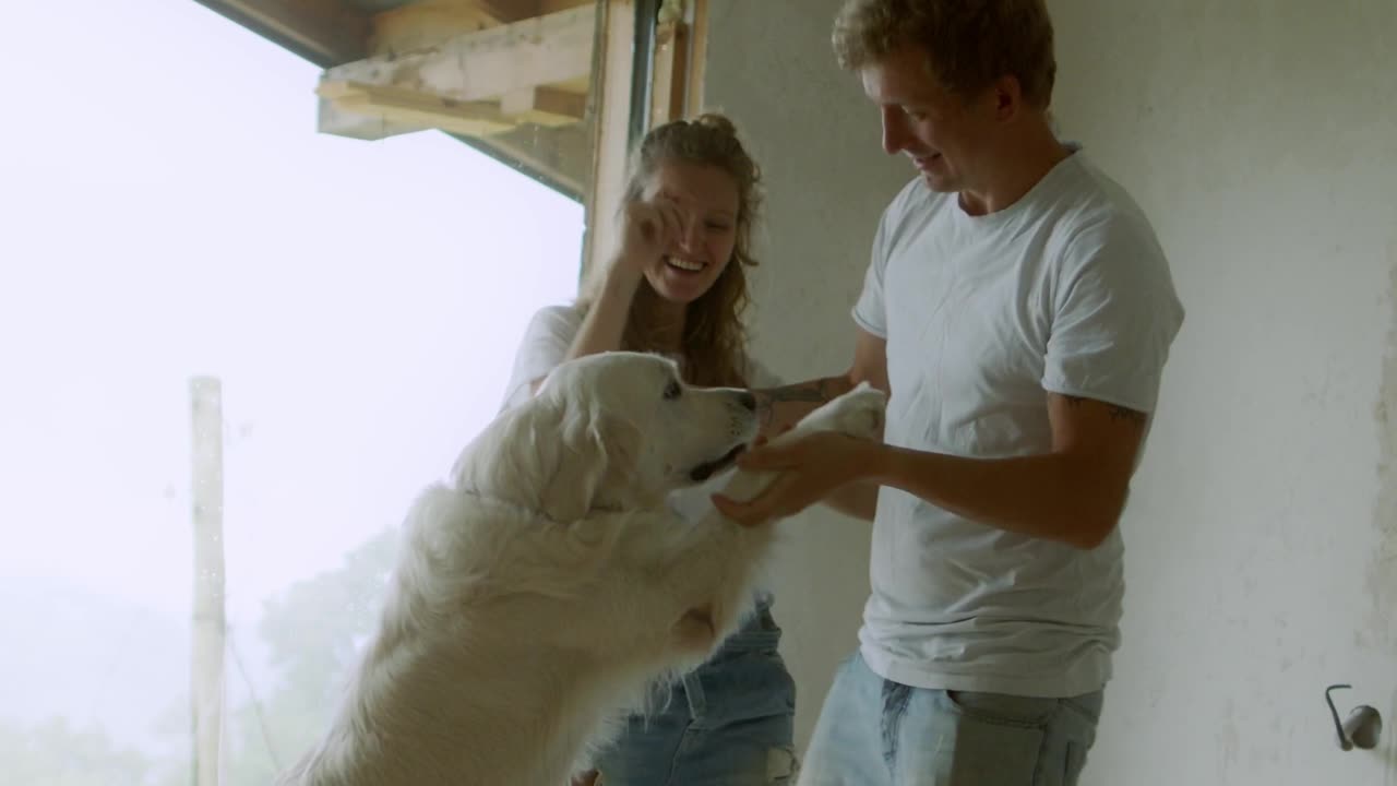 A man and women training dog for dance