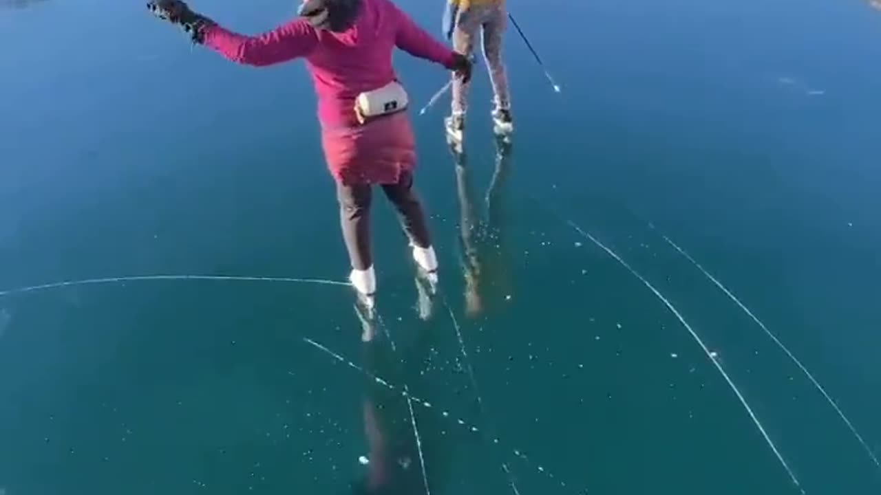 Skating over the clear glassy ice of rabbit lake in Canada
