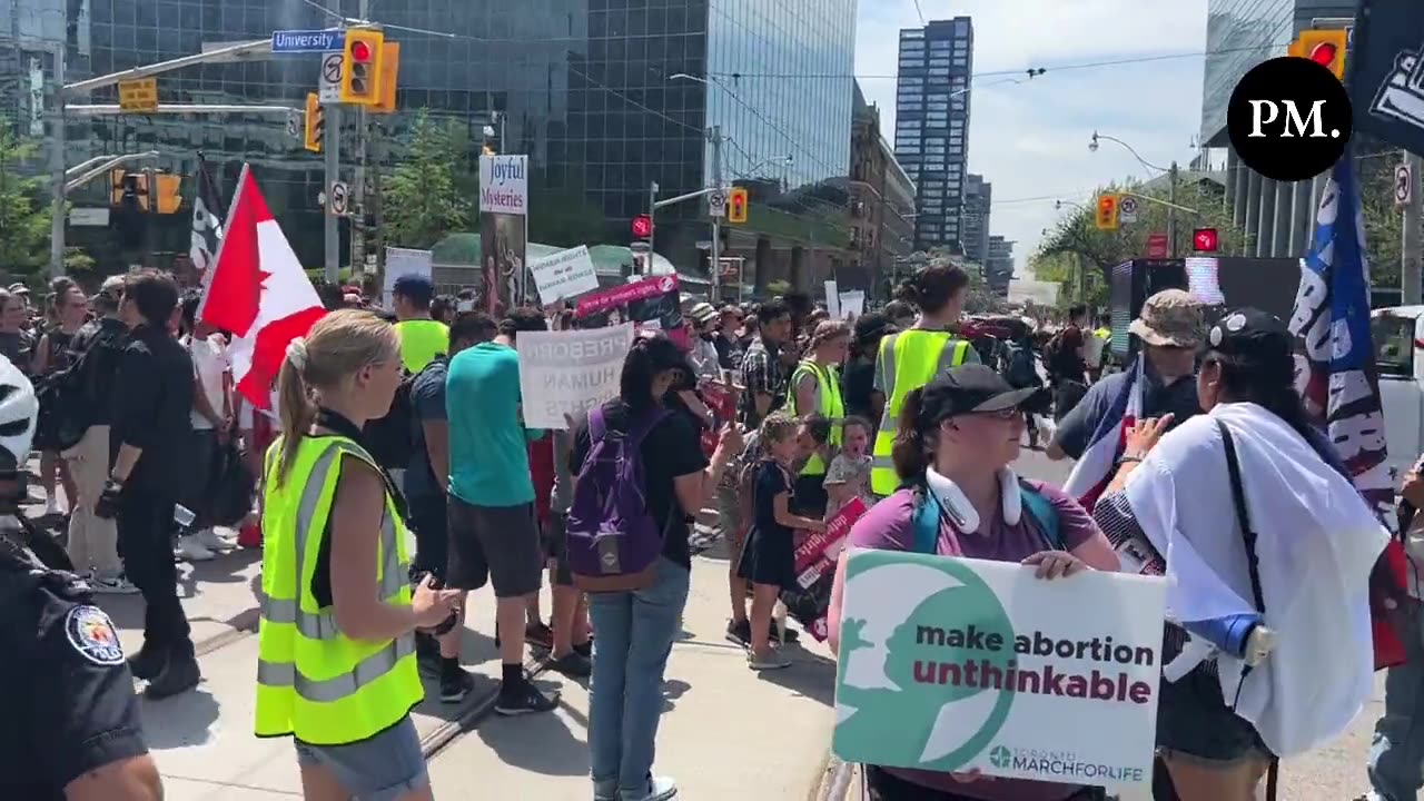 While participants in the Toronto March for Life observe a moment of silence near a hospital