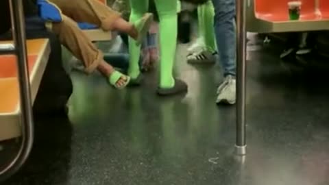 Group Of Women In Neon Green Bodysuits Descend NYC Subway Into Chaos