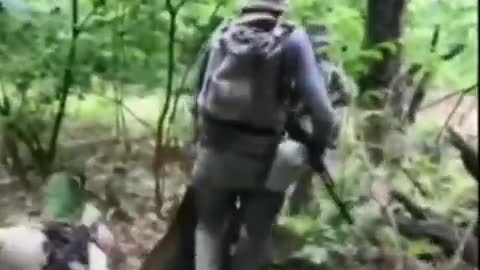 Ukraine War - A group of Ukrainian military carries the wounded
