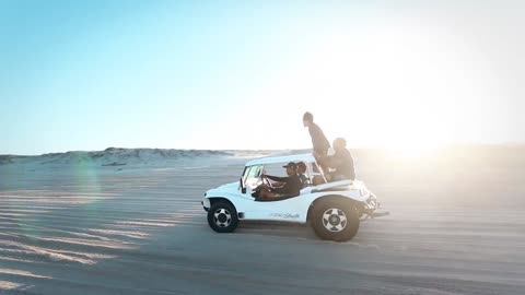 Two Vehicles Traveling In The Desert