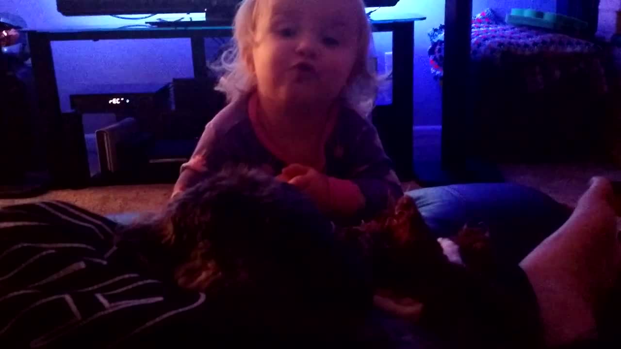 Adorable toddler talks with puppy