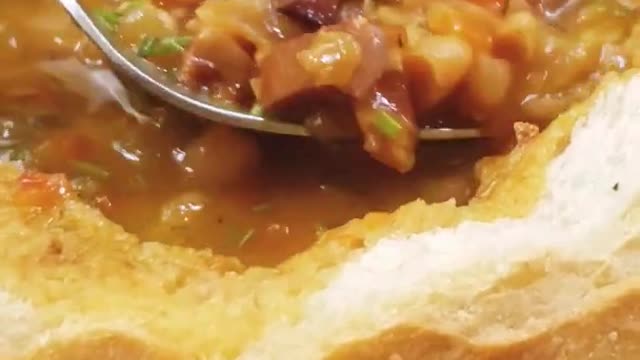 Romanian food tasting - bean soup with smoked pork in a bread bowl