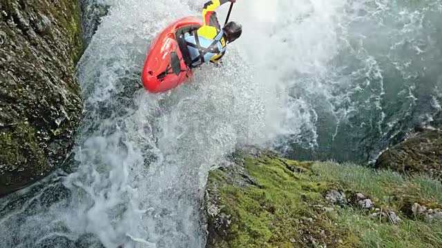 person riding a red kayak