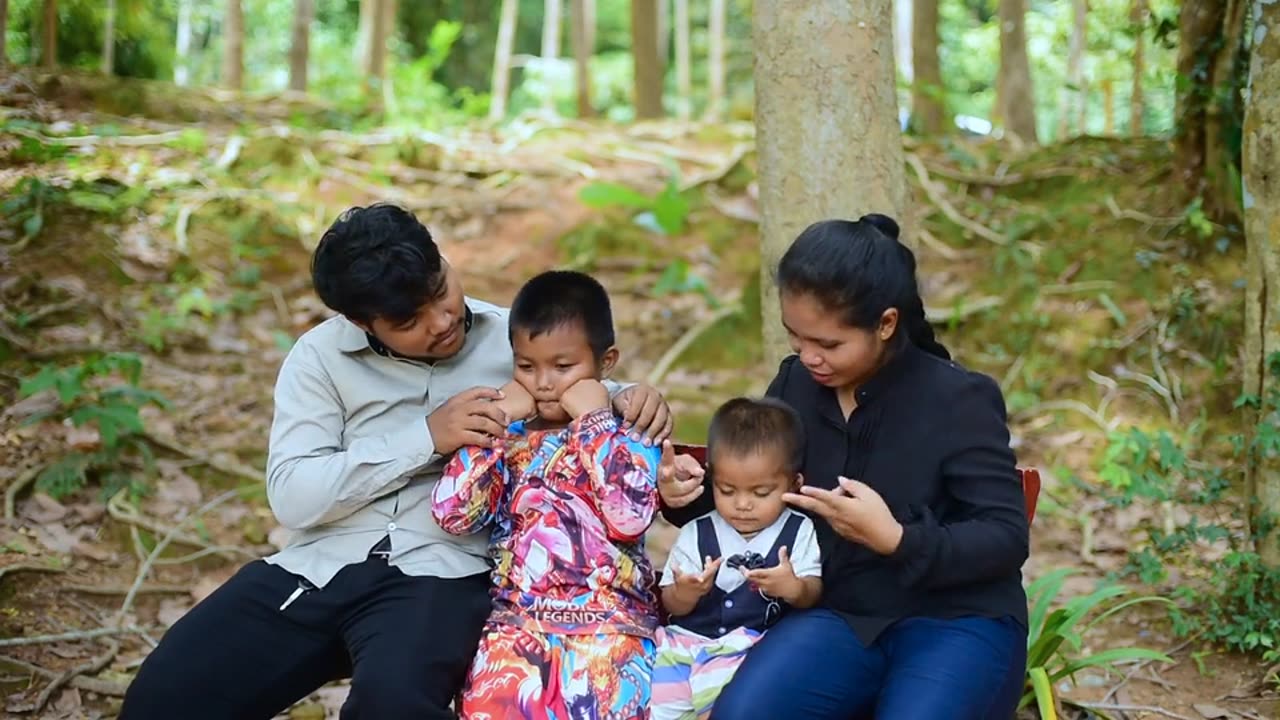 Thai family playing happily on the bench