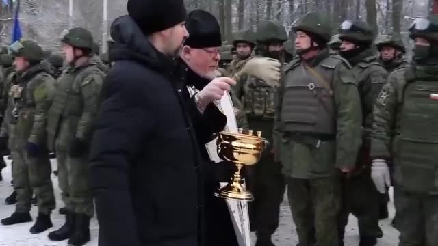 Some soldiers hold the Russian imperial flag while others hold the 1945 victory flag