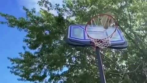 Guy Performs Trickshot With Football by Kicking it Inside Basketball Hoop