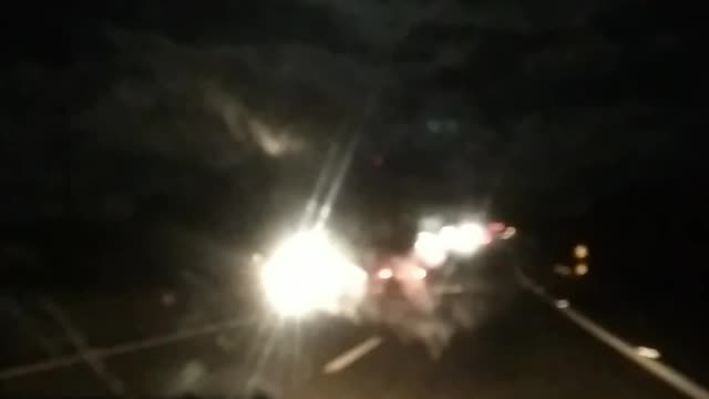 Driving in the road at night.