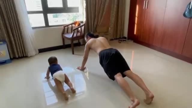 Baby and dad doing morning exercise