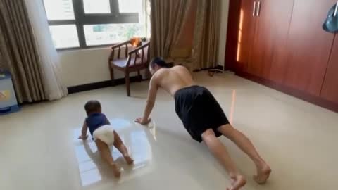 Baby and dad doing morning exercise