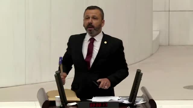 Turkish lawmaker smashes phone with hammer in parliament to protest social media bill