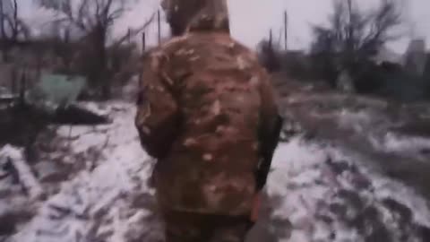 A destroyed Ukrainian M113 APC in a ruined neighborhood of Marinka