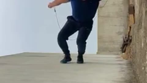 an Jumps Rope While Balancing Sideways On wall