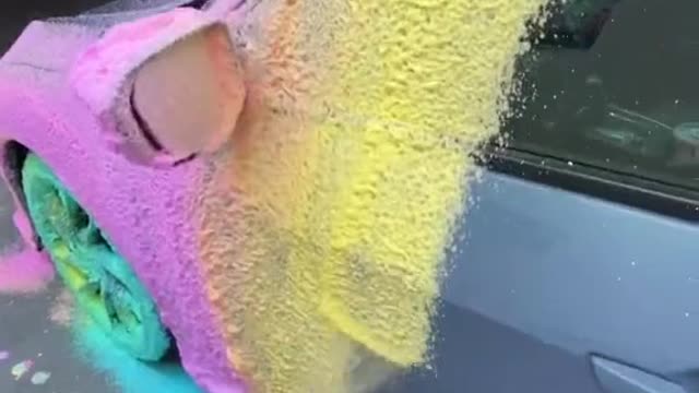 Spray colored foam before washing the car