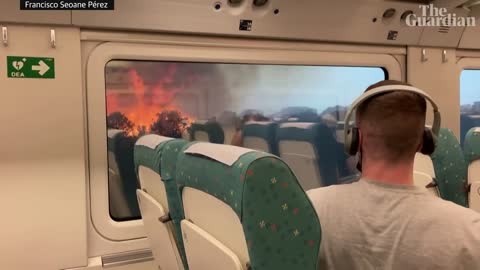 Spain heatwave: passengers struck in train surrounded by wildfires