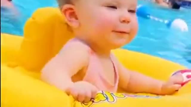 Cute baby dancing on the pool