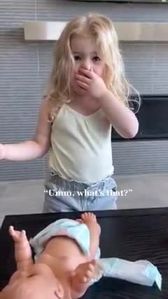 Little One Changing The Doll's Diaper