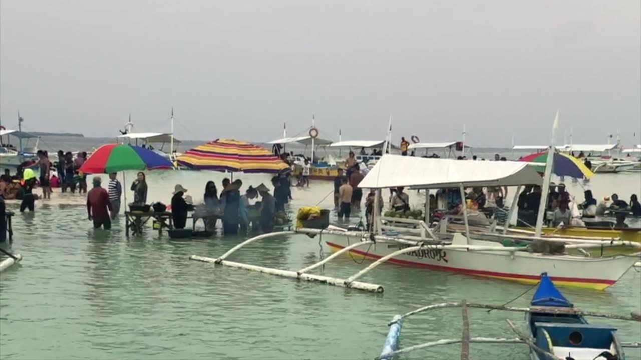 Many tourist visiting a sandbar in Bohol Philippines