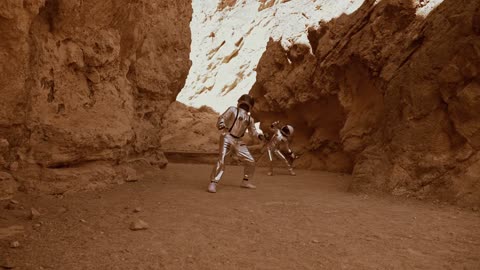 An Astronaut standing near the rock formation