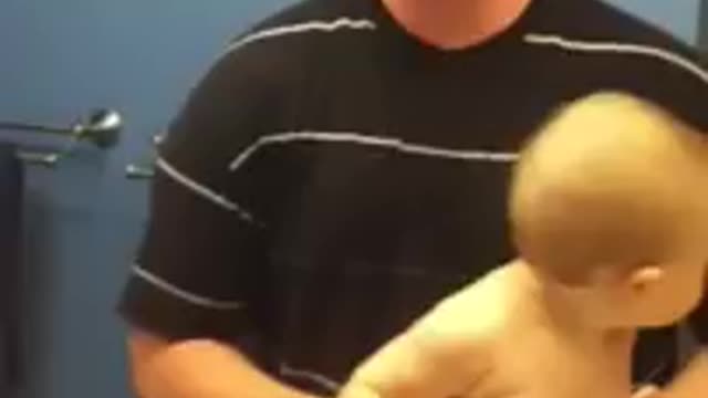 Adorable baby flexes muscle with dad funny