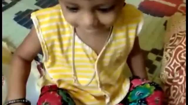 Baby is playing happily at home.