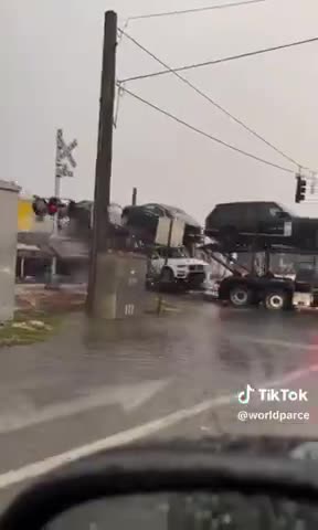 Car transport truck gets hit by train. Miami, Florida