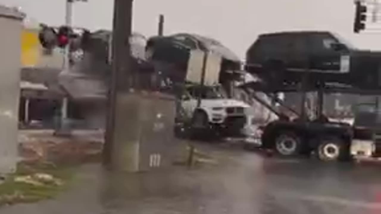 Car transport truck gets hit by train. Miami, Florida