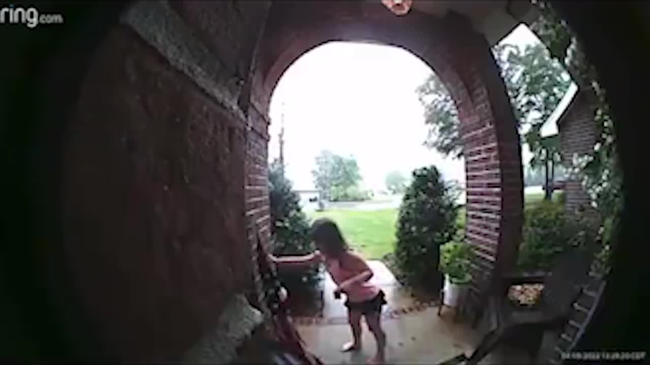 Little Girl Picks Up Flag After a Storm Knocked It Down