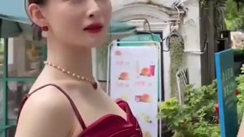 Chinese Woman in Red Dress Dodging Bat