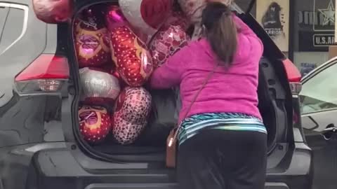 Woman hilariously struggles to fit balloons in her trunk