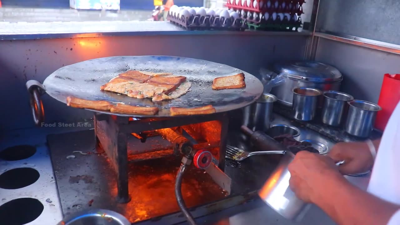 boy making bread omelet in India