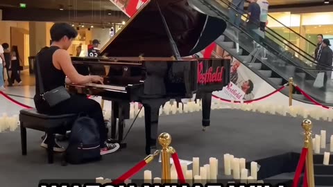 A Violinist appear on the escalators