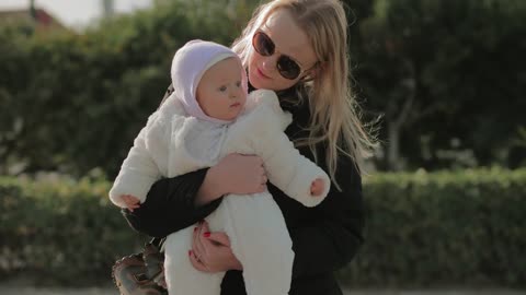 Mother and baby swaying in the park