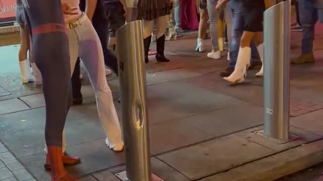 Person in Spider-Man costume partying on Lower Broadway